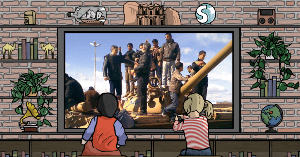 Alcune persone in piedi su un carro armato durante la Primavera araba in Libia, che portò alla caduta del regime di Gheddafi